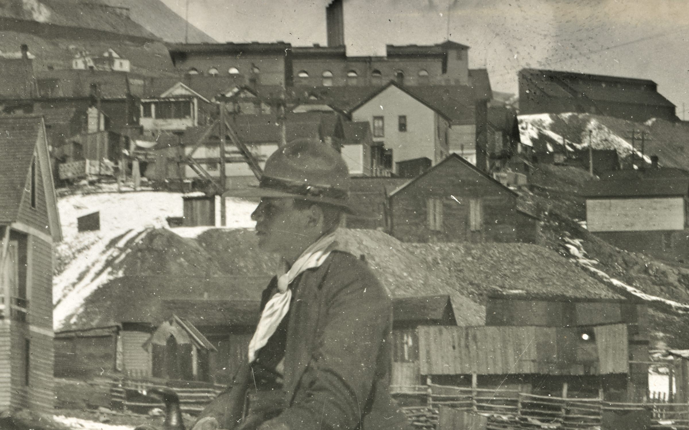I think this image is at the eastern end of Spicer Avenue, and that the mine seen with its Head-Frame behind the head of the rider in the foreground is the Fortuna Mine, but I might be off as this been hard to decode fully where it was photographed, it might be even further south in Victor.
   In background top right, about 1/4 down from top and covering about first 1/4 in from right-hand side there is seen the Ore-House of the Independence Mine. Also, about center sideways and about 1/5 down top is the brick structure of the Victor High School seen blocking most of the view to the Shaft House of the Independence Mine.
   At the top left corner there is seen the massive dumps of the Portland Mines and part of the Crib-wall below the No. 2 Shaft is seen, so yes, the mines really set their feel on town.