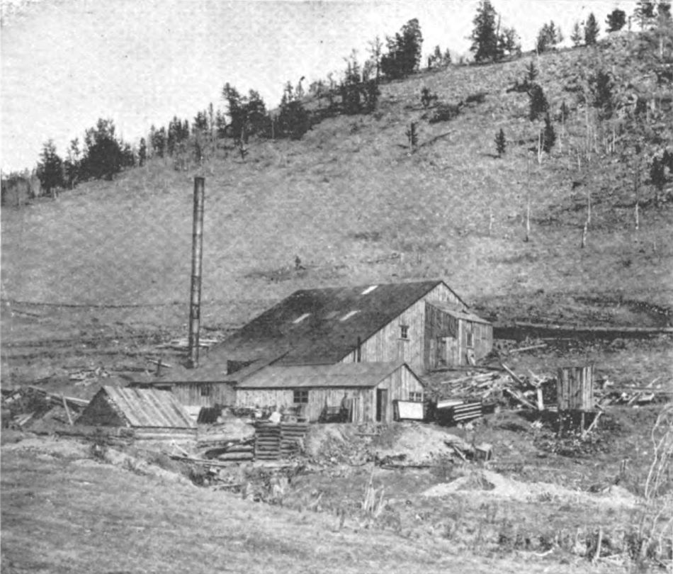    This is the only known (to me, as of 12.01.2017) view of the Gold Geyser Mill structures, located along the creek named Cripple creek, about halfway between Mound City and southern part of town of Cripple Creek, a little south of the Ophelia Tunnel.
   View shows a small wooden mill structure on a hill side, the creek is just below the structures and there is possible a water wheel across the creek hidden inside the log structure seen near left-hand side view of the lower half of it. But the smokestack also indicates they run on either wood or coal, and I guess there is two levels inside this mill judging from the side look of it.