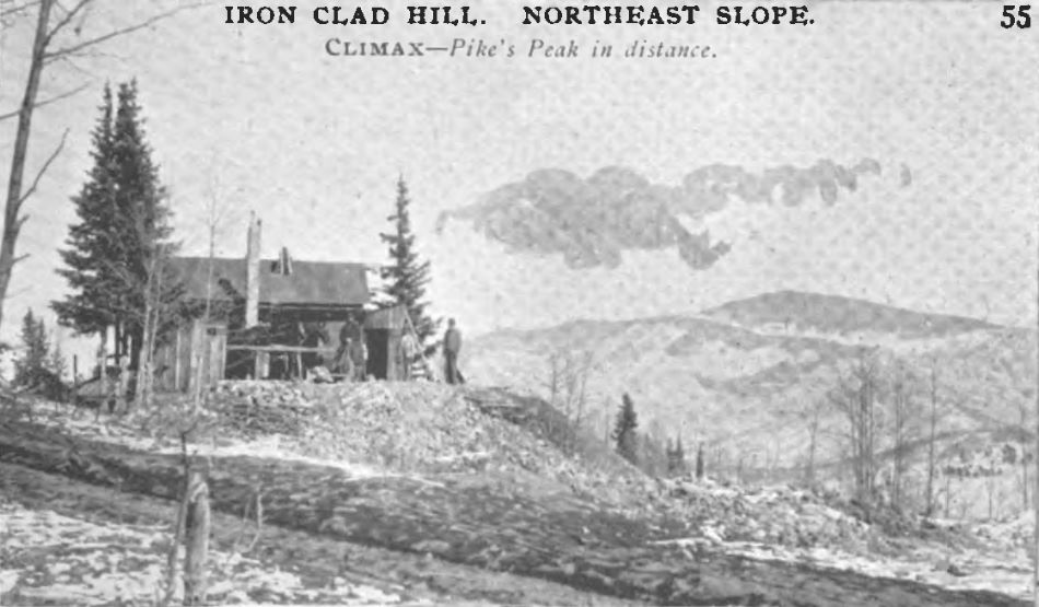 This view from the northeast slope of Ironclad hill is looking east towards Pike's Peak in the background, with a small mine operation visible on the left half of this view. The photo on DPL has more ground in front, but no more structures or anything useful really.
In terms of the mine itself, it appears to use a horse hoist, set up on a small dump in front of the main structure with a small shed attached to the right-hand side of that, strangely enough with the roof of that shed sloping towards the main structure for some reason. There appears to be patches of snow on the ground and ice drippings hangs from a plank that acts like a water collector or something from the roof, seen best on the DPL photo behind the horse.