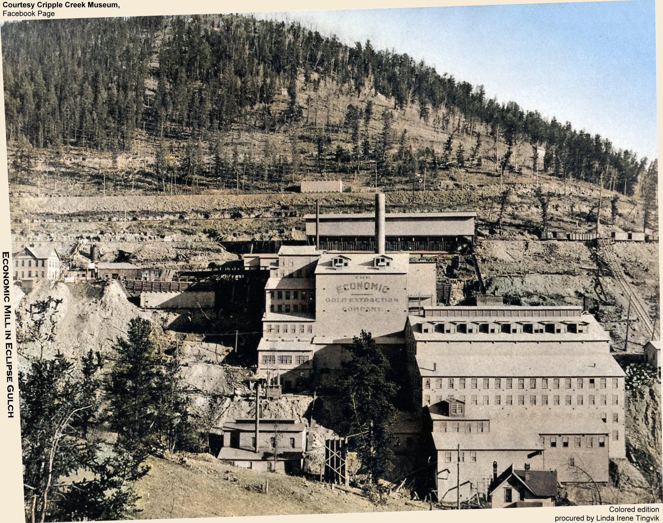 This is a view of the second edition of the massive Economic Mill in Eclipse Gulch, on the west part of Squaw Mountain. First edition stopped at the large wall in lower right with all the windows on it. Around 1903 there would be other changes, the most visible one is that the tunnel portal structure changes from what I her see as a shed like structure into a larger house look with an arched entry.
   Regarding this scene though, they have built the Ore-shed up at the railroad yard where the 3-foot narrow-gauge F. & C.C. enters from the left, while from the right, the Short Line had a spur coming in from a sort of switch back as the roadbed of the Low Line and Short Line is seen about 1/3 down from top of image, the second highest roadbed in this view. There is a square Water-tank of 52000-gallons size that was iron-cladded up there alongside the tracks of the Low Line. Above that track is the Midland Terminal, and below is the mainline of the F. & C.C.
   The structure all the way at left about middle top/down was a brick structure holding the Office and Assay Office, while the smaller structure about 1/3 in from left-hand side and just up from bottom, the one with the high narrow smokestack on it, as per a Sanborn Fire Insurance map, was also a brick structure holding a boiler and marked as Laboratory. Rest of the structures seen are wood covered in iron-clad sidings, painted.
   I did procure the colored version of this image. Source was gray-toned, or in common speech black & white. Used an online service and tweaked and worked with image to get what looks best to my eyes for the moment.