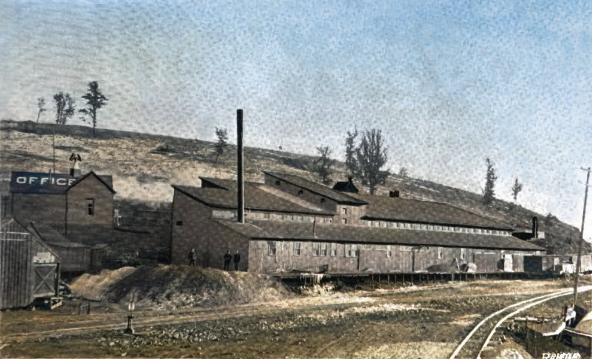 This sadly bad view of the Rio Grande Sampler, former Cripple Creek Sampler, is the best one of the very few known views of this sampler which was located at south end of the town of Cripple Creek. Located just below the mainline of the Florence & Cripple Creek railroad, at the approach to its yard, which would be outside the view at left, behind the structure marked as Office.
   This used to be the sampler of the Cripple Creek Sampling and Ore Company, but they built a new sampler further up Gold Hill, along the Midland Terminal, and later at Victor Pass on Bull Hill and this sampler here was sold to the Rio Grande Sampling Company.
   The view appears in a 1898 publication, so it is too early for the showing of the Short Line loop which will later be on the hill in the background, but I have seen this structure on images with the loop so I know the structure lasted at least into the 1900's, but how long and how successful this sampler was, I do not know as when the few text pieces I find about a Rio Grande Sampler don't say the location it might as well be talking about the one down in Victor.
   I did procure the colored version of this image as I think it is nicer. Source is gray-toned, or in common speech black & white. Used an online service and tweaked and worked with image to get what looks best to my eyes for the moment.