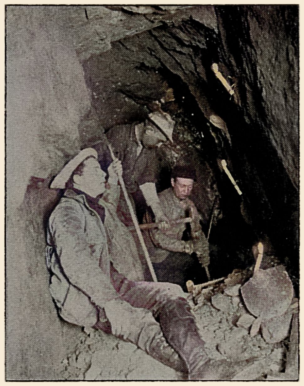 Miners at Work Underground in Candle Light