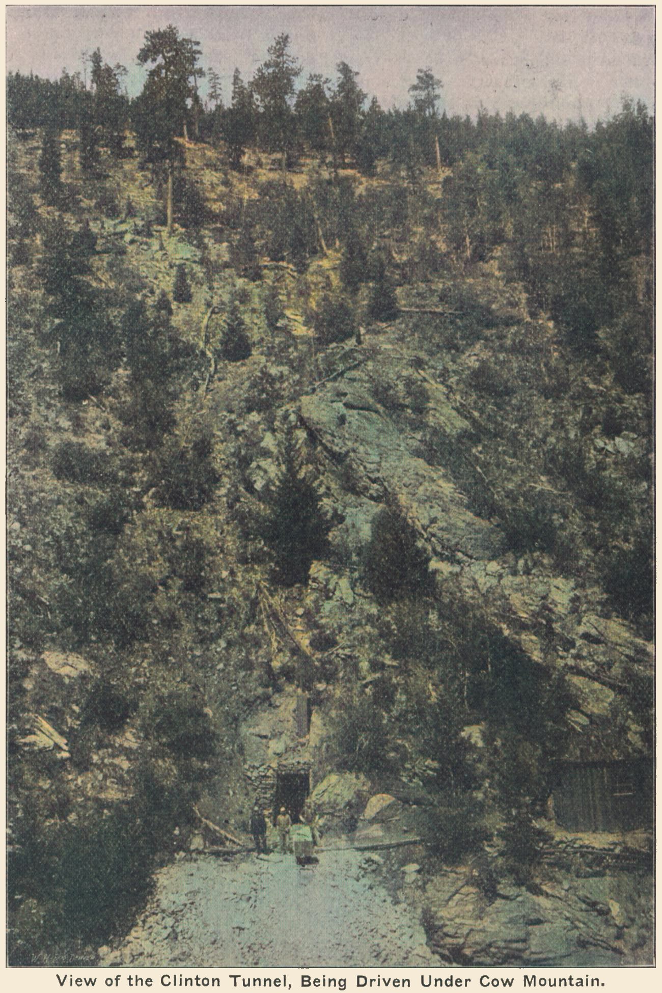 This might very much just be an illustration of a Tunnel type of mine, not at all linked to the Clinton Tunnel or even the Cripple Creek District. There is no sign of the Short Line roadbed, and it is hard to say for sure this is the mine or what. But the same image appears in this Seeing Cripple Creek book, claiming to be of the Clinton Tunnel, so possible it might be it is a true image of the tunnel mouth?
Either way, this is a non-profitable mine, laying very much on the outside of the District, close to where the Short Line crosses over Beaver Creek and the railroad has its own route to/from the district after leaving the parallel run from about Cameron with the M.T. roadbed, where the M.T. goes around a hill and head north towards Gillett, and the Short Line heads east.
-> By end of July 2016 the thinking this is the real Clinton Tunnel was very much killed off by a much better view of was called the site of the Clinton tunnel, feeling more real, when comparing to Google Earth view, but even that is not 100% correct as it is still ''doctored'' a little at the mouth of the tunnel itself...
   Scenery on this particular view do not match the scenery at the site I think this is located at, here it is to steep and to much trees, feels more like they needed a tunnel mine view and just took what was available at the time the publication went to print.
   I did procure the colored version of this image. Source was gray-toned, or in common speech black & white. Used an online service and tweaked and worked with image to get what looks best to my eyes for the moment.