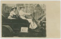 Two Ladies Posing in an Automobile in a Photographers Studio, Sign Saying 'Leaving Denver'