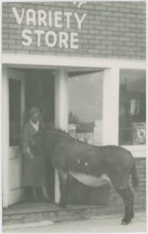 Donkey in Doorway with Lady, Structure is Marked 'Variety Store' Above the Doorway